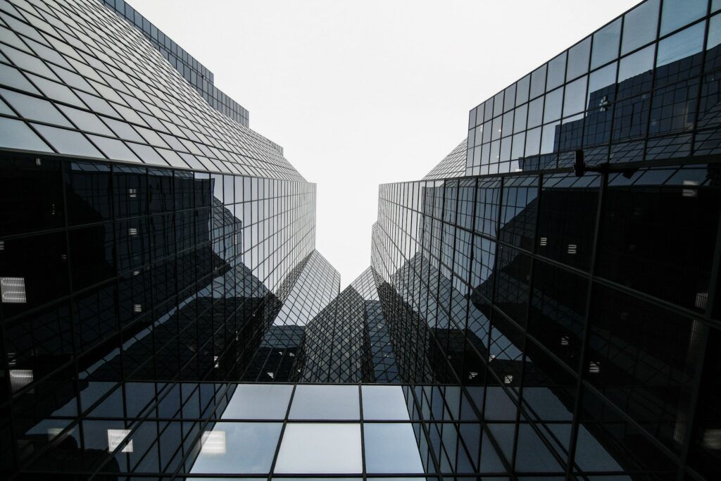 A View Of Large Glass Facades With A Sky In The Background.