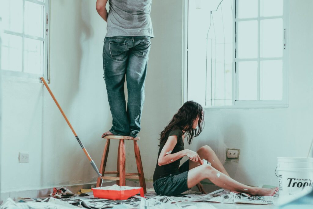 A Couple Paints A Room In Their House.